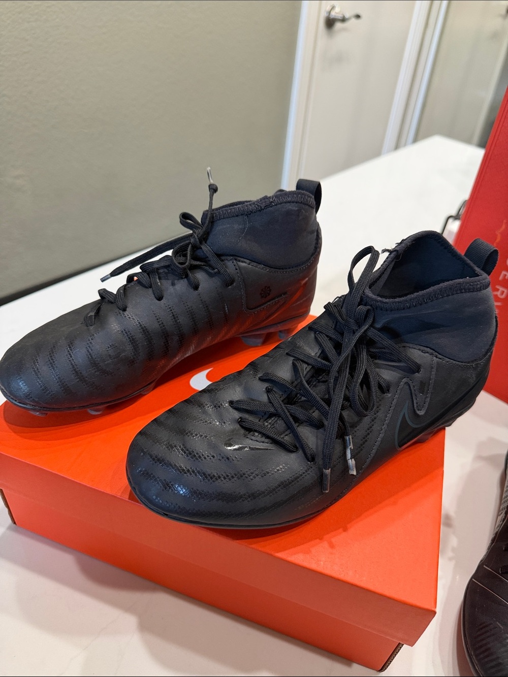 Nike Men’s Black High-Top Soccer Cleats with Orange Box Accent